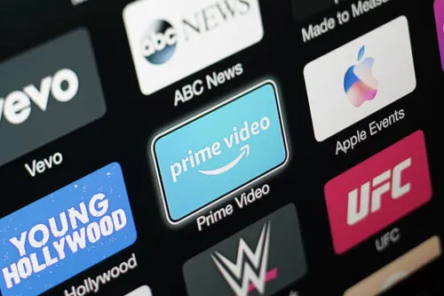 Close-up of an Apple TV screen showing the Prime Video app icon surrounded by other app icons (ABC News, Apple Events, UFC, WWE, Vevo).
